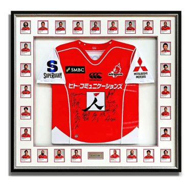 A frame showcasing a team signed Sun Wolves rugby jersey along with all team members' photos.