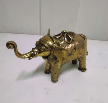 "Handcrafted shiny brass baby elephant with tribal engravings, left side view-Going abroad"