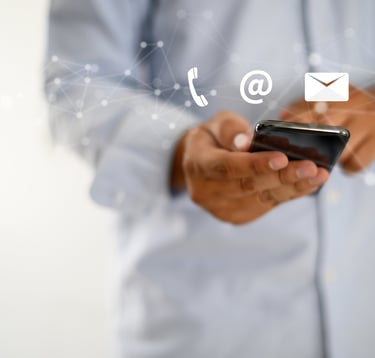 a man in a blue shirt is holding a cell phone