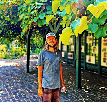 a healer man with a warm smile that is inviting and calming