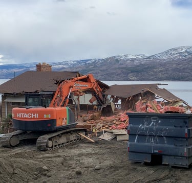 a construction site with a large excavator and a dumpster