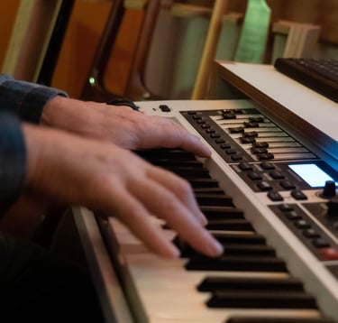 Luke Stidworthy playing a keyboard at Vox Studio