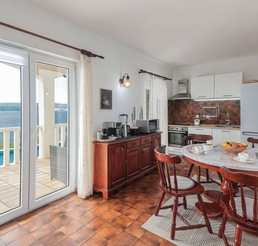 The photo shows the apartment's kitchen and dining area with household appliances.