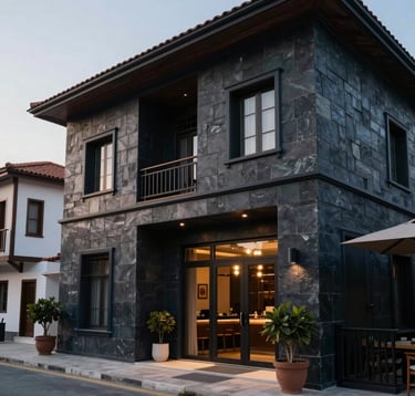 A modern boutique hotel exterior in a Middle Eastern / Turkish coastal town, featuring dark slate navy architectural details and soft lighting, professional lifestyle photography.
