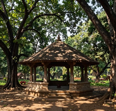 A serene South Asian / Indian landscape showing a traditional open-air pavilion built with natural stone and wood, nestled within a dense grove of sacred neem and peepal trees, dappled sunlight on the floor.
