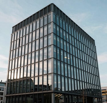 Photography of a modern glass building in a business district in France, reflecting a clear sky. Architecture is minimalist and geometric, representing professional reliability and strength.