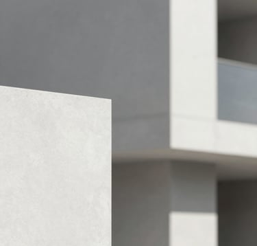 A minimalist architectural detail of a luxury construction project. Clean white concrete surfaces (#F8F8F8) and grey stone accents (#A9A9A9). Natural daylight creating soft shadows. Sophisticated and professional atmosphere.