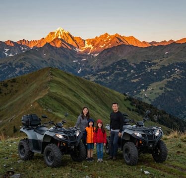 A wide-angle shot of a family standing together on a lush green mountain ridge next to two modern cuatrimotos. The South American Andean landscape stretches out behind them with orange and yellow sunlight illuminating the peaks.