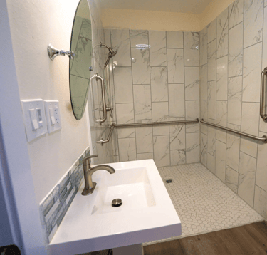 Adult Family Home bathroom with grab bars, and slip-resistant tile flooring