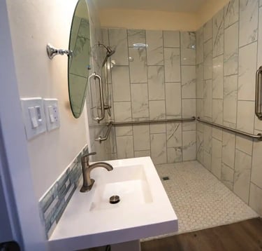 Adult Family Home bathroom with grab bars, and slip-resistant tile flooring