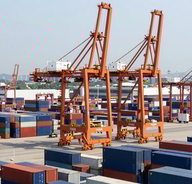 A high-angle photography shot of a busy commercial port with giant orange cranes and stacks of dark blue containers, modern industrial aesthetic, bright daylight, Global Business.