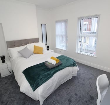 bedroom with bed and white walls