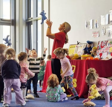 Children taking part in a Jo Jingles music and movement class at Sewards End Village Hall near Saffron Walden.