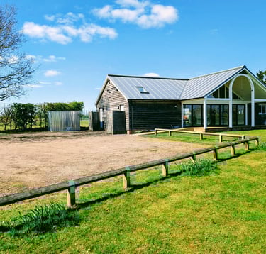 Exterior of Radwinter Pavilion showing the building and parking area in Radwinter near Saffron Walden