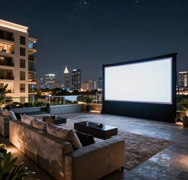 An exclusive rooftop cinema setup on a luxury Indian apartment building. Plush outdoor seating, a large screen under the starry night sky, and ambient floor lighting with the glowing Ranchi skyline in the background. The scene reflects high-end living and sophistication.
