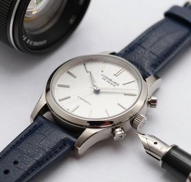 Macro photography of a high-end luxury watch and a fountain pen on a desk. Sharp focus, clean composition, using deep midnight navy and pristine soft white tones.