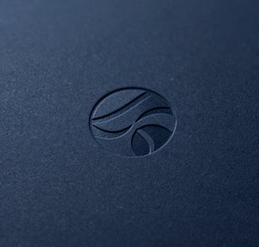 A close-up macro photograph of a corporate logo subtly debossed into premium dark navy #0A1118 paper. The texture of the paper is crisp and detailed. Lighting is minimalist and focused, highlighting the precision of the print design. Professional and sophisticated vibe.