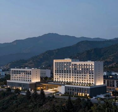 A wide-angle, breathtaking landscape of modern hotel architecture nestled in a mountain range during the blue hour. Cool tones of #1E2B38 mixed with soft hotel lighting #D2C9B0. Minimalist and premium travel aesthetic.