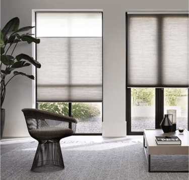 Movann motorized honeycomb shades in an elegant living room with a couch and a chair
