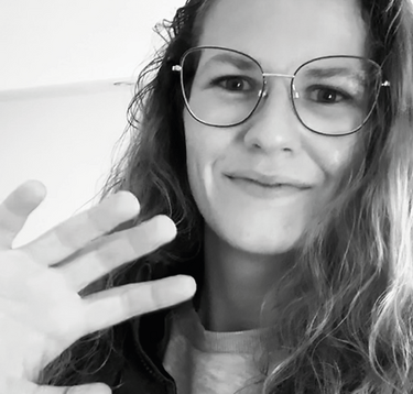 a woman with glasses and a jacket on