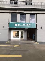 a building with a large green sign that says kfc
