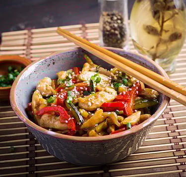 Grilled chicken with zucchini, herbs, and sauce on a plate