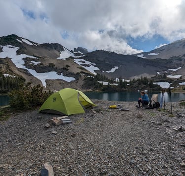 Nemo Dagger 3p tent pitched near a blue alpine lake in the Olympic Mountains.
