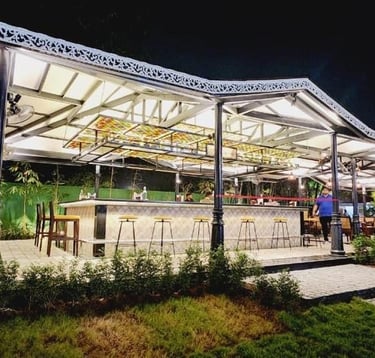 a restaurant with a large glass roof and a long table
