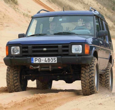 Jeep driving over sandy dunes during a 4x4 adventure near Riga