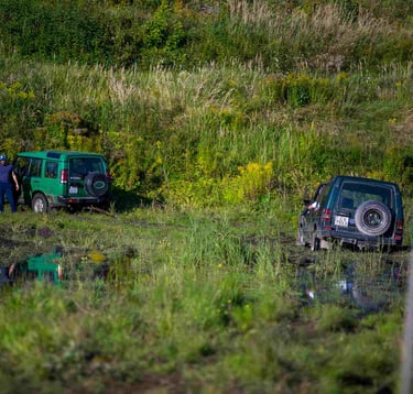 Muddy off-road track with a 4x4 vehicle outside the city of Riga