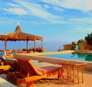 Bedouin star pool with lounge chairs and umbrellas