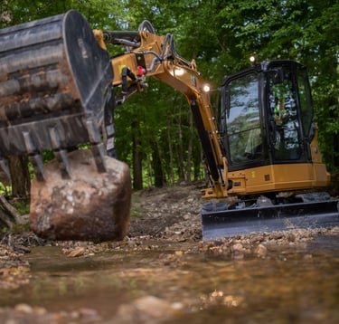 east west clearing and excavation contact Us pic of excavator moving rock
