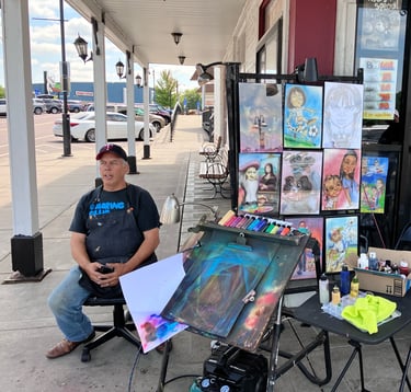 A Broadway Street artist waiting for his next challenge. 
