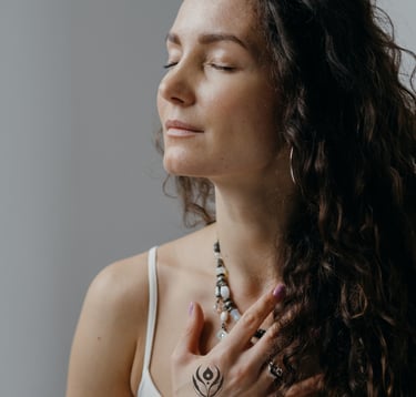 woman holding hand on chest