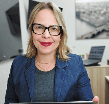 a woman in glasses and a blue blazer jacket