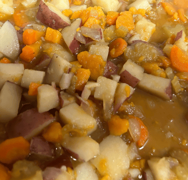 Vegetable soup with a blend of potatoes, sweet potatoes, carrots, celery and broth shown.