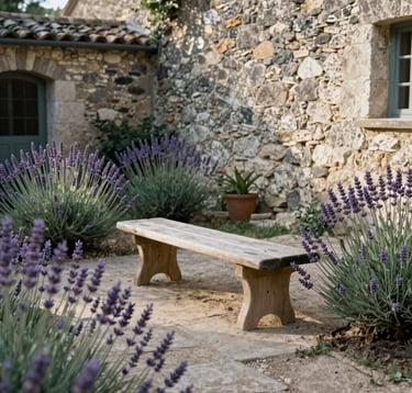 An outdoor meditation space with a simple wooden bench, surrounded by lavender and old stone walls in a Western European / French garden. Soft morning sunlight. Warm Greige and Sage Teal color palette.