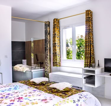 Bedroom with bathroom and toilet, television, air conditioner and pool view at Domaine Des Lucques