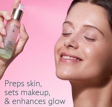 Elegant woman spritzing Caudalie Beauty Elixir onto her face with eyes closed, enjoying a refreshing