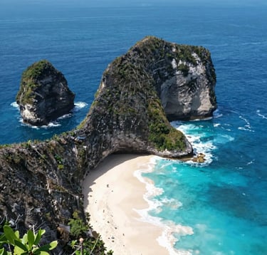 A breathtaking view of Kelingking Beach, Nusa Penida, from the cliffs. The ocean is a deep professional blue (#1B2D3B). The image captures the 'stunning Indonesian destination' mentioned in the brief, with high clarity and a modern, clean photographic style.