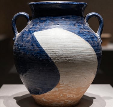 High-contrast photography of ancient, textured pottery from a world culture. The lighting emphasizes the earthy textures and deep shadows. The color palette consists of Deep Midnight Blue shadows and Pearl White highlights.
