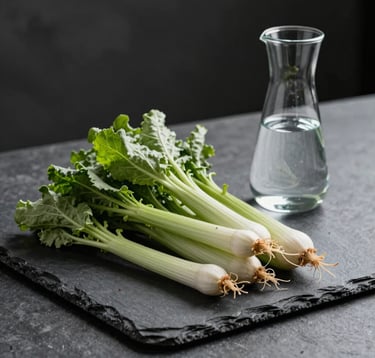 A minimalist, high-end photography shot of fresh, organic vegetables and a clean carafe of water on a slate surface. The lighting is sharp and scientific yet natural. Muted sage green and charcoal tones dominate, reflecting a sophisticated approach to nutrition.