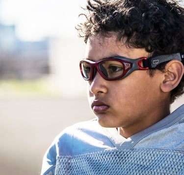 Child wearing safety sports goggles