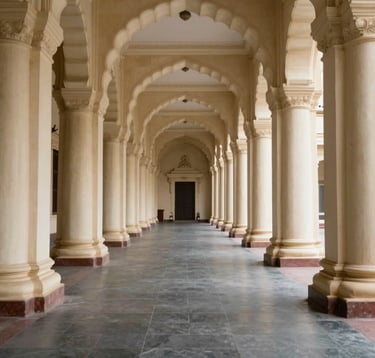A wide-angle, symmetrical shot of a grand South Asian / Indian High Court corridor. The architecture features Ivory pillars, Dark Slate floors, and sophisticated lighting that creates an atmosphere of authority and historical importance. No people present.