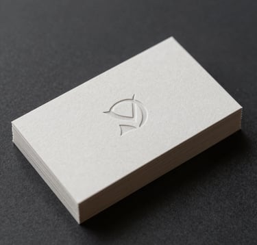 Close-up detail of a minimalist branding project. A stack of premium textured paper business cards in #F8F8F4 with a debossed, sophisticated logo mark. The cards rest on a dark #0F1E2E background. Professional studio lighting emphasizes the crisp edges and refined texture of the paper. Minimalist and high-end aesthetic.