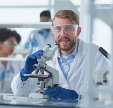 A scientist looking into a microscope