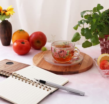 a notebook with a pen and a notebook with a pen and a cup of tea