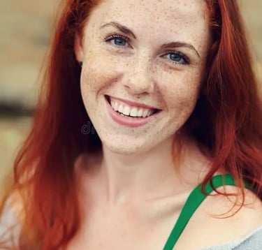 a woman with red hair and a green top