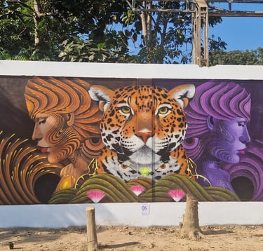 Street art mural featuring a central leopard face flanked by two profile portraits of stylized women.