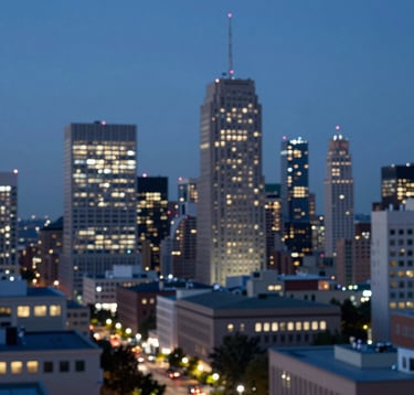 A wide shot of an urban cityscape at dusk with a focus on institutional buildings. The lights are coming on, symbolizing continuous work and commitment. Blue and navy tones #0F1D2C dominate with points of light #F4F7FA.